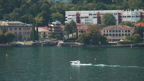 Seaplane. Ultralight aviation in Lake Como, Italy Hobbies and sports. Tourism. Hydroplane. Airplane in the air and on the water