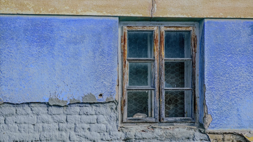 Video zoom, picture of an abandoned house. Window detail. Image for further graphic processing