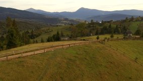 Spring rural landscape in the evening light from a bird's eye view. Location place Carpathian mountains, Ukraine, Europe. Aerial footage, cinematic drone shot. Filmed in UHD 4k video. Beauty of earth.