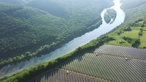 Aerial footage over photovoltaic solar panels from a bird's eye view. Concept of save clean planet. Location Dniester canyon, Ukraine, Europe. Cinematic drone shot. Filmed UHD 4k video. Beauty earth.