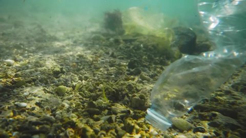 plastic pollution in oceans, underwater video. plastic pollution crisis, disposable plastics, single-use cups and bottles in the Red Sea
