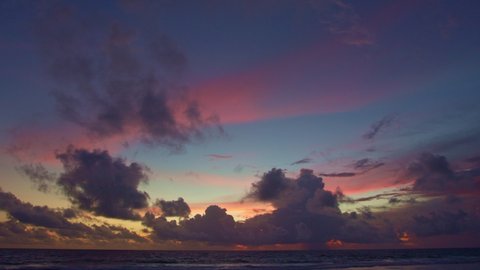 
colorful light through to the cloud above the ocean.
Clouds are moving slowly in stunning sunset video 4K. Nature video High quality footage 
Scene of Colorful romantic sky sunset background.