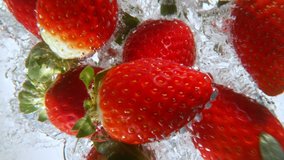 Strawberries falling into water, super slow motion, filmed on high speed cinematic camera at 1000 fps. - Powered by Shutterstock - Get 15% off with code: PIKWIZARD15
