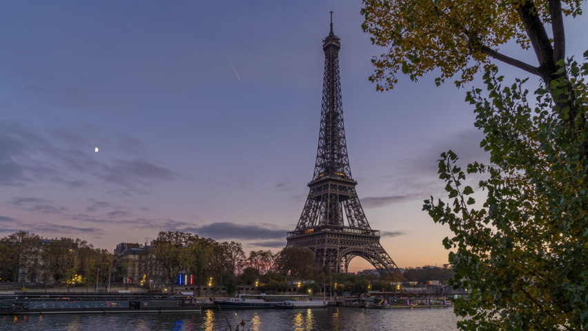 Eiffel Tower at Blue Hour With Moon in a Cloudy Sky in Paris Fall Colors Tree | Shutterstock HD Video #1087058036
