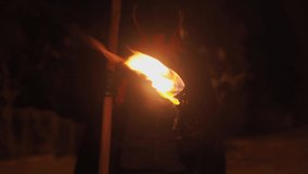 Theme is fear of death. Burning torch in hands of death with a scythe at night. Death with a scythe with a burning stick in his hands for Halloween. A man with a scythe in a suit of death with fire - Powered by Shutterstock - Get 15% off with code: PIKWIZARD15