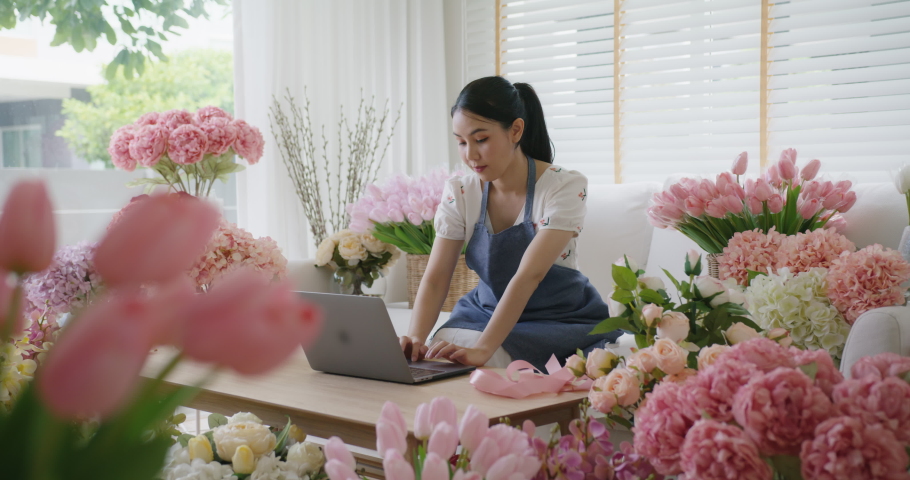 SME owner modern small flower shop work at home office happy smile fist up read text e-mail message banking lending money online. Young adult woman asia people joy seller job in sale order good news. Royalty-Free Stock Footage #1087069670