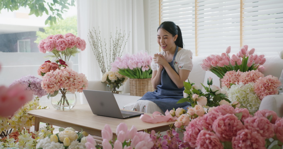 SME owner modern small flower shop work at home office happy smile fist up read text e-mail message banking lending money online. Young adult woman asia people joy seller job in sale order good news. | Shutterstock HD Video #1087069670