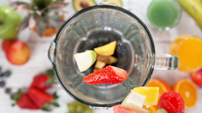 Super slow motion of falling pieces of fruits and water splash into blender. Filmed on high speed cinema camera, 1000 fps. Speed ramp effect.