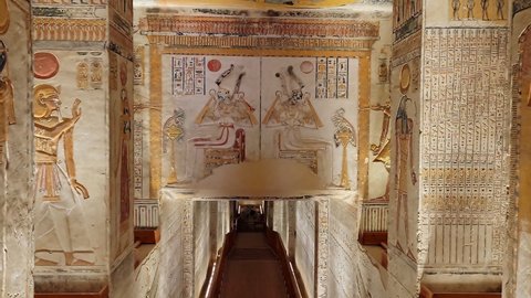 Luxor, Egypt - November 2021: Turists in Corridor with ancient Egyptian inscriptions and a tomb. The Valley of the King tomb KV9.