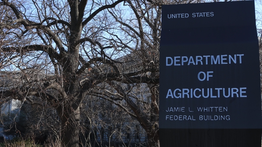 A sign for the United States Department of Agriculture Jamie L. Whitten Building on the National Mall in downtown Washington, DC. The camera pans from left to right.