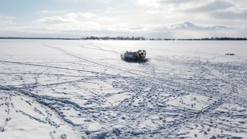 hovercraft rides on the frozen lake. High quality 4k footage