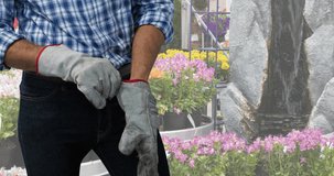 Animation of caucasian male worker wearing gloves over garden. international workers day and celebration concept digitally generated video.