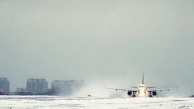 Passenger plane takes off at the airport its wheels come off the runway covered with snow in winter in bad weather top slow motion video