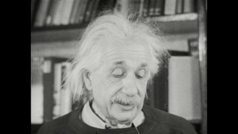 1940s: Albert Einstein stands near bookshelf and speaks.