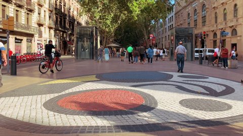 Barcelona, Catalonia - Spain - September 15 2021: Paviment Miró in Barcelona Ramblas with tourists walking by.