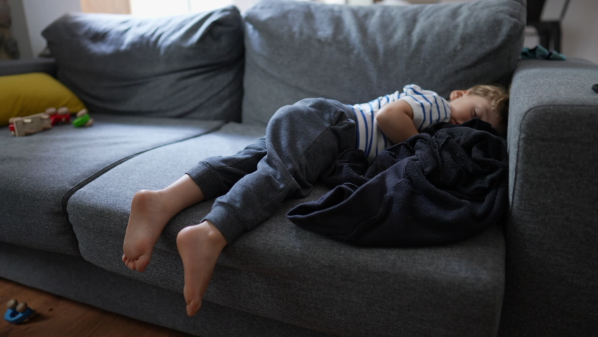 Child napping on couch in the afternoon