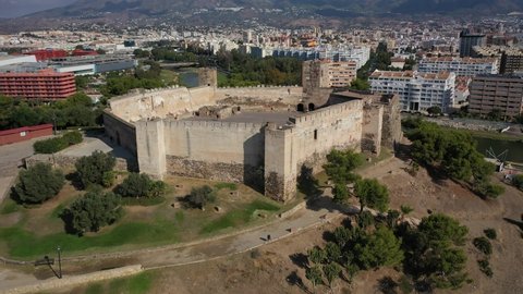 Aerial 4K video from drone to Fuengirola historic Sohail Castle. Is shown in the background Rio Fuengirola Pedestrian Bridge.Fuengirola Malaga ,Spain, Europe (Series)