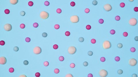 6k Creative pattern with pastel gummy candies move on bright cyan background. Stop motion flat lay concept