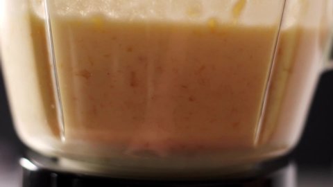 Whipping mango yogurt, for making a traditional lassie drink
