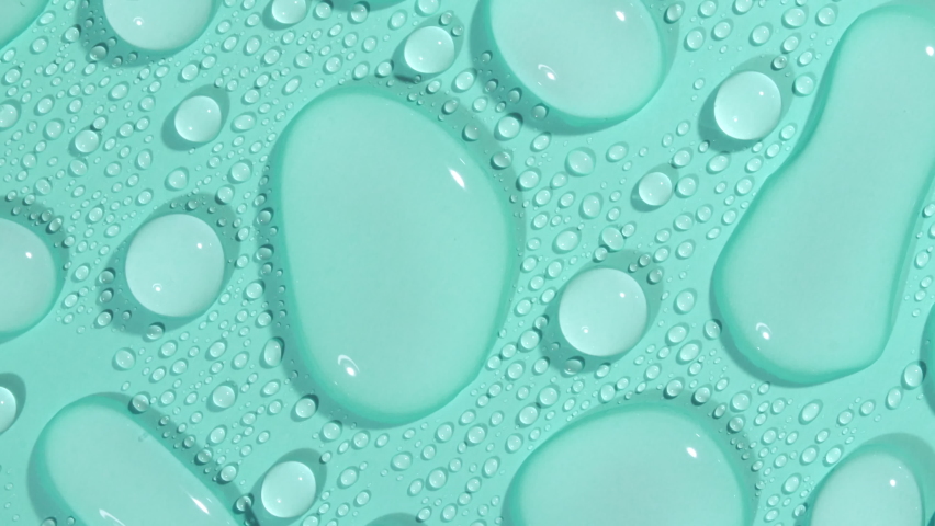 Macro Shot of Cosmetic moisturizing drops of liquid on a green-blue pastel background. Rotation of transparent cosmetic gel fluid, Hyaluronic acid. | Shutterstock HD Video #1087110509