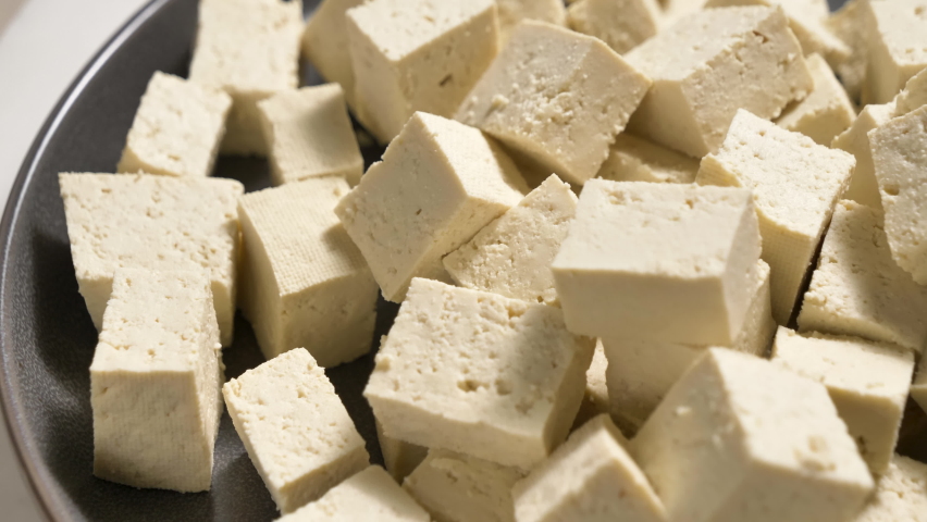 Tofu chunks closeup. Plant based diet. Vegan protein source. Healthy eating. Soybean product Royalty-Free Stock Footage #1087112996
