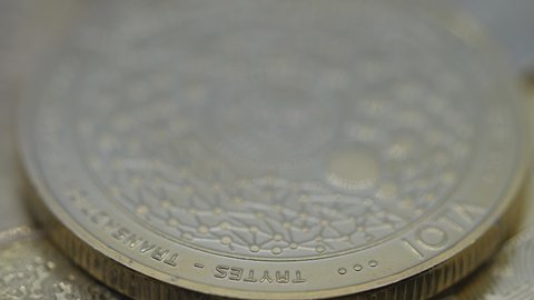 A close up view of a spinning Iota crypto coin.