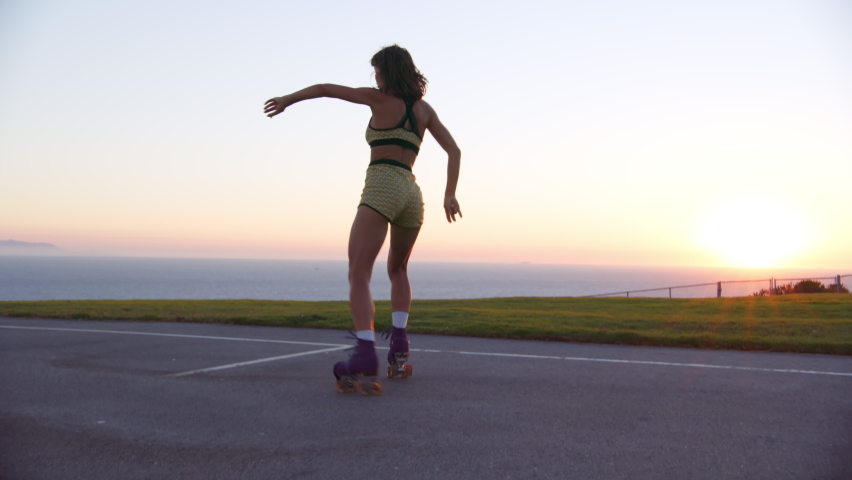 Idyllic natural summer landscape with beautiful sunset skyline and ocean view. Beautiful and healthy woman riding roller skates in the park within seascape. High quality 4k footage | Shutterstock HD Video #1087114613