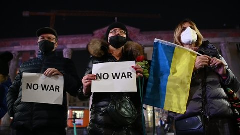 Milan, Italy - February 16, 2022: People hold banners during a pacifist #nowar flash mob to call for peace as tension rise between Russia and Ukraine