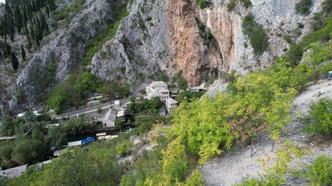Drone view of the historical ottoman monastery built on the side of the Buna river, the islamic dervish lodge built under the mountain in Mostar