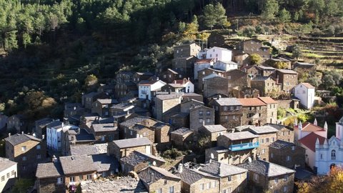 DRONE AERIAL FOOTAGE: The picturesque little schist villages of Piodão clings to a steeply terraced mountainside deep within the foothills of the Serra de Açor range in central Portugal.