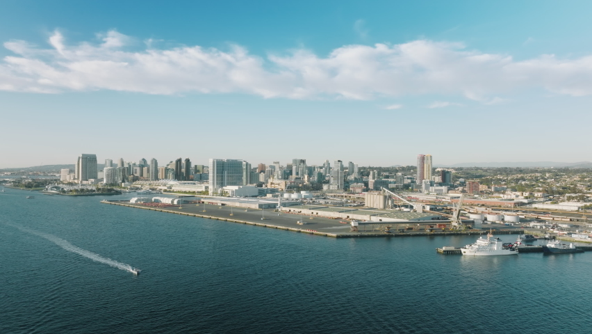 Cinematic aerial downtown San Diego on sunny summer day with beautiful white clouds in clear blue sky. The finest city of America with water front high hotel and residential buildings, California, USA Royalty-Free Stock Footage #1087122515