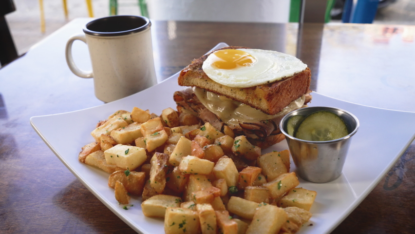 Breakfast platter, home fries with breakfast sandwich topped with a sunny side up egg, slider 4K