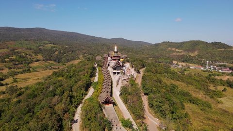 Steady aerial footage of the famous Wat Somdet in Phu Ruea as people climb down and up the stairs of the temple, Ming Mueang, Loei in Thailand.