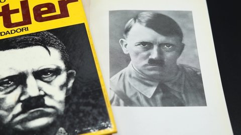 Rome, Italy - February 12, 2022, Rome, detail of the cover of the book Pro and Cons - Hitler and an image of Hitler in the book entitled My battle, Italian translation of Mein Kampf.