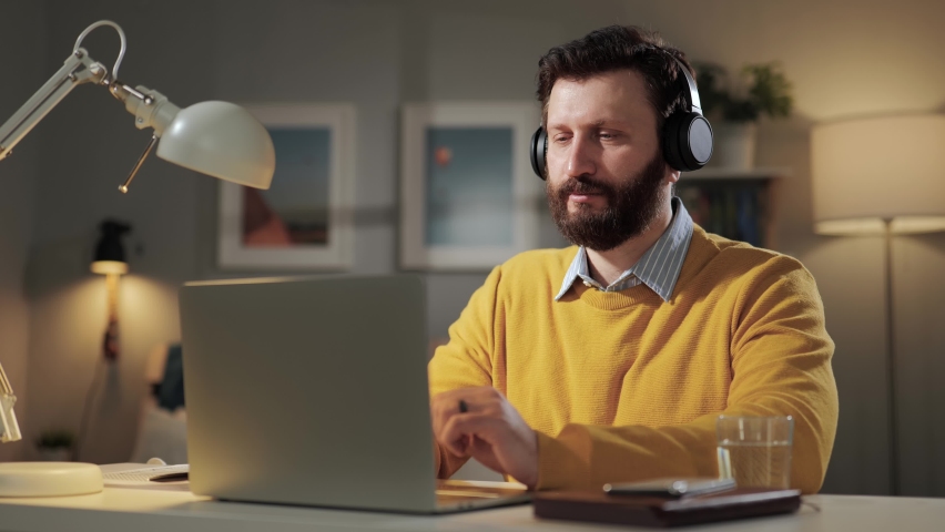 Man thumbs down, disagree emotion. Serious displeased bearded man with headphones in home office looking at computer webcam and shows his hand with thumb down Royalty-Free Stock Footage #1087129271