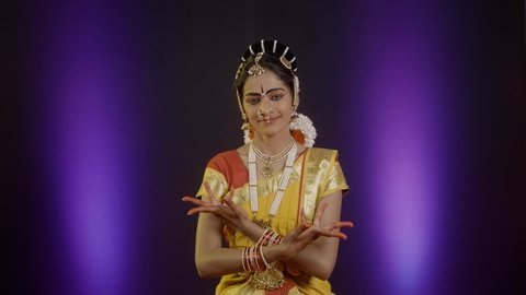 bharatanatyam dancer hands showing Avahittha hasta form or hand gesture while performing on stage - concept of classical dance, traditional art and bharatanatyam mudra.