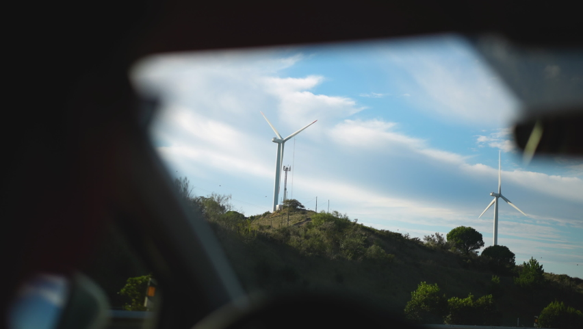 Electrical windmill or wind turbine with rotating blades. Sustainable energy concept. Eco-friendly resource of energy. Renewable car electricity source. Modern industrial windmill turbines in Europe. Royalty-Free Stock Footage #1087132784