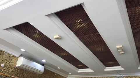 Doha,Qatar-February 10th 2022:Suspended gypsum false ceiling with decorative lights and air conditioned for small coffee shop