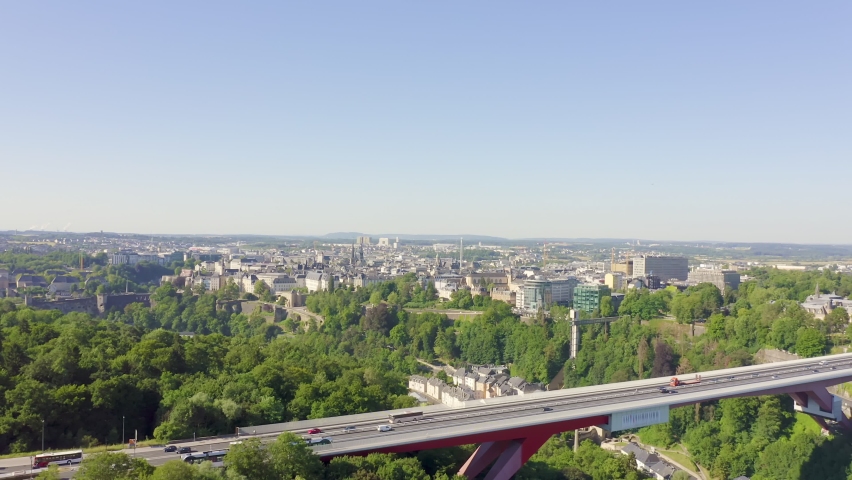 Inscription on video. Luxembourg, Historical city center in the morning. Pont Rouge. Blue lights form luminous. Electric style, Aerial View