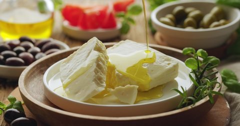 Feta cheese drizzled with olive oil, close up view