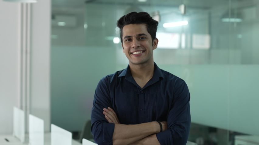 Beautiful smiling confident young Indian ethnic man pretty face looking at camera posing alone at home in office, happy millennial Hindu ethnicity male student professional close up front portrait. | Shutterstock HD Video #1087144538