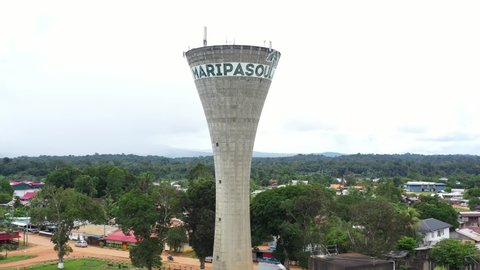 Maripasoula, French Guiana - 2022 : Drone aerial view starting from the water tower then flying above the town. Maroni river and Suriname country in back