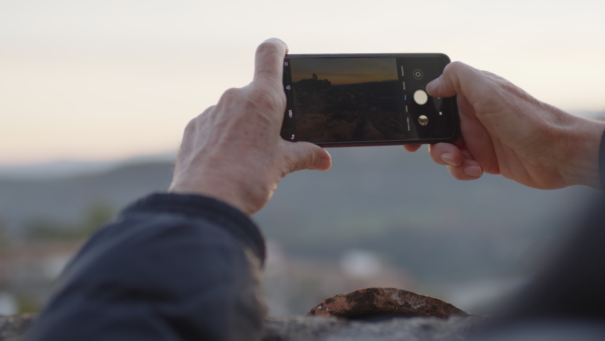 man taking photos with smart phones 