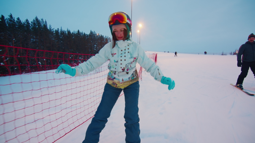 Young woman learns snowboarding and gets stuck in the safety net