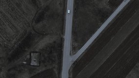 Travel journey transport and vacation concept High angle aerial view drone video on the road following car driving in autumn or winter evening near Nis in Serbia top down