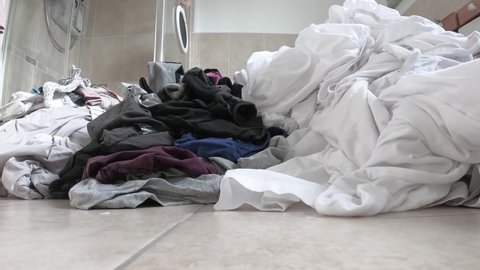 Time lapse of laundry piling up in the bathroom