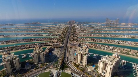 Dubai, UAEmirates - febr 17 2022: Time lapse of the traffic created through the glass walls of the 220m high observation deck of the Palm Tower near the new Nakheel Mall on Palm Island.
