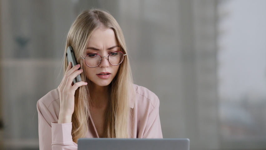 Angry caucasian woman call phone at office work place annoyed girl talking mobile conversation upset mad female worker boss leader cellphone argue quarrel misunderstanding problems negative emotions Royalty-Free Stock Footage #1087158662