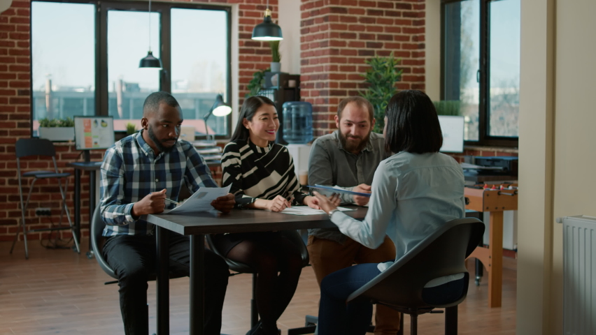 Diverse group of workers attending job interview meeting with applicant, talking about work experience and cv information. Female candidate cooperating with HR department employees. Royalty-Free Stock Footage #1087159541