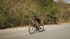 Cycling cardio workout exercising. Cyclist riding bicycle. Woman cycling on bike. Training on bike. Fitness workout. Triathlete rides on bike, preparing for triathlon cycling race competition